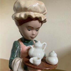 Vintage Nadal girl holding a tea set